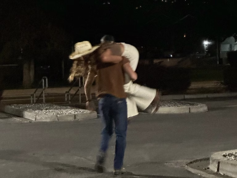Man carrying woman over his shoulder